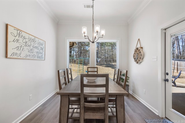 dining room with visible vents, baseboards, ornamental molding, dark wood finished floors, and an inviting chandelier