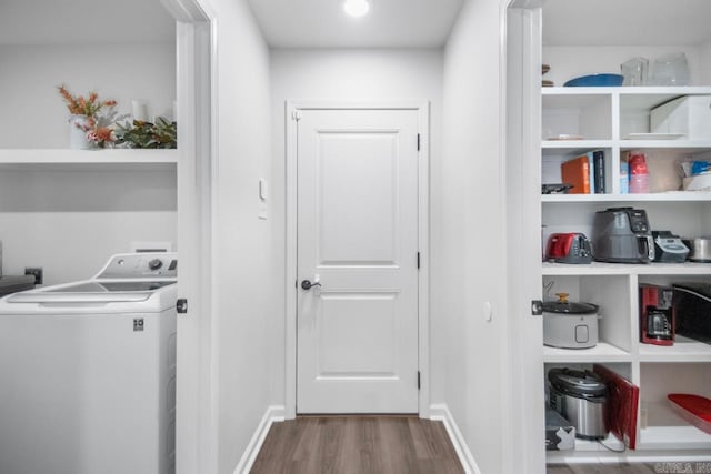 washroom with laundry area, washer / clothes dryer, wood finished floors, and baseboards