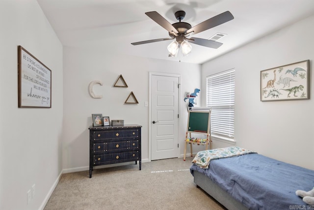 carpeted bedroom featuring baseboards, visible vents, and ceiling fan