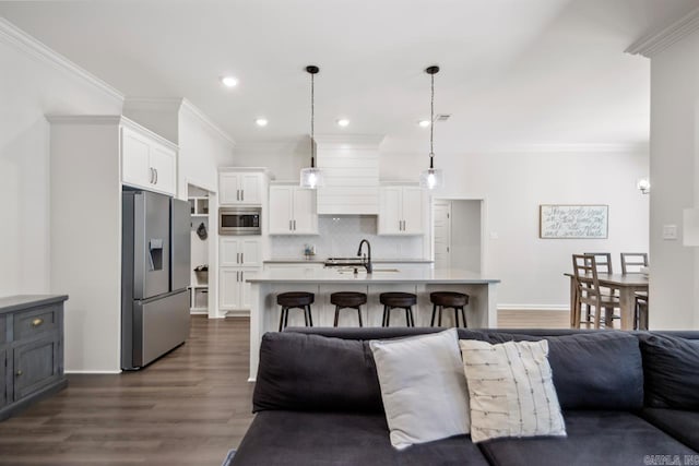 kitchen with tasteful backsplash, white cabinetry, appliances with stainless steel finishes, and open floor plan