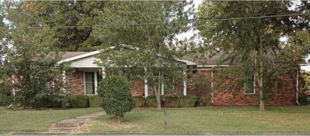 obstructed view of property with a front lawn