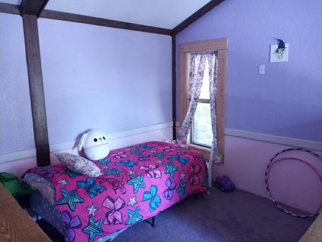 bedroom with lofted ceiling and carpet floors