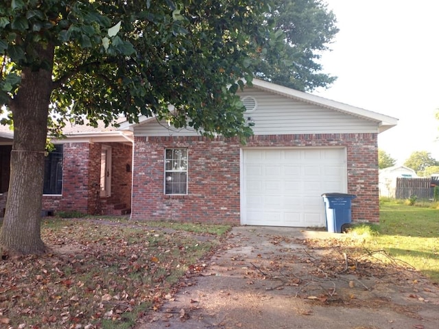 view of property exterior with a garage, concrete driveway, and brick siding