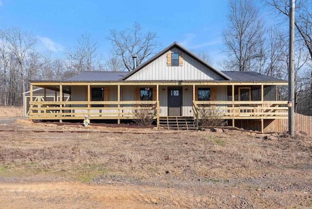 country-style home featuring covered porch and metal roof