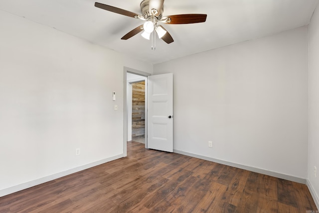 spare room featuring a ceiling fan, baseboards, and wood finished floors