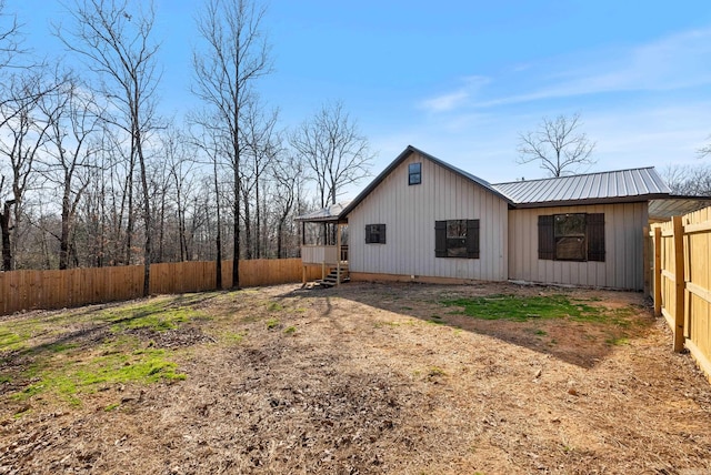 view of side of property with fence private yard and metal roof