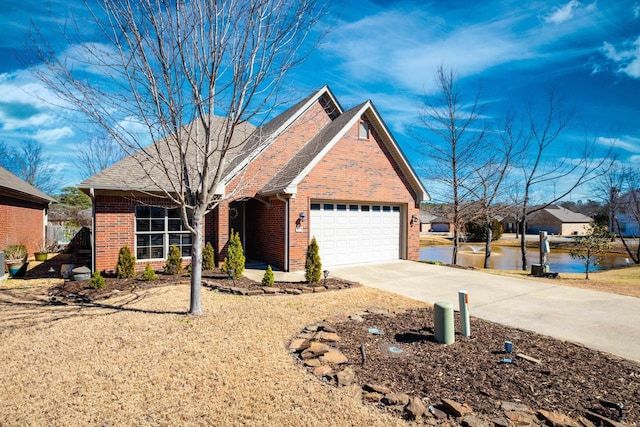 view of front facade with driveway, a garage, and brick siding