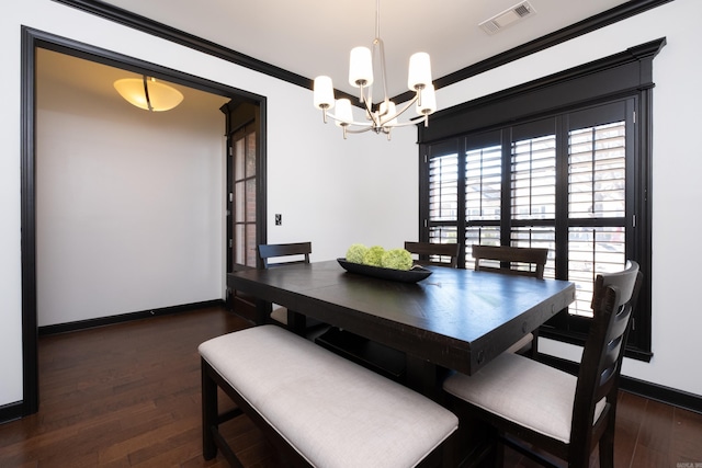 dining room with visible vents, an inviting chandelier, ornamental molding, wood finished floors, and baseboards