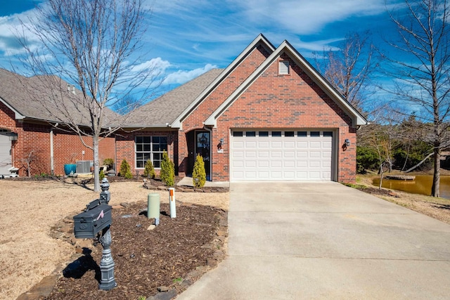 view of front facade with concrete driveway, brick siding, roof with shingles, and an attached garage