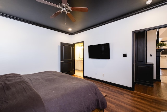 bedroom with baseboards, ornamental molding, wood finished floors, and ensuite bathroom