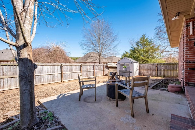 view of patio / terrace with a storage shed, an outdoor structure, and a fenced backyard