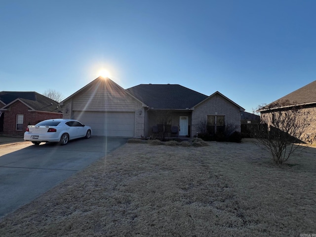 single story home featuring a garage and driveway