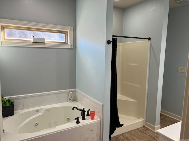 bathroom with a whirlpool tub, a stall shower, and tile patterned flooring