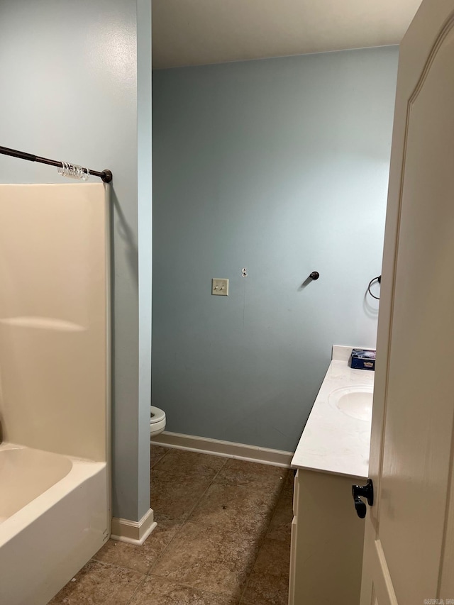 full bath with toilet, tile patterned flooring, baseboards, and vanity