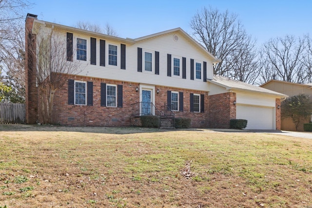 colonial house with brick siding, a chimney, crawl space, an attached garage, and a front yard