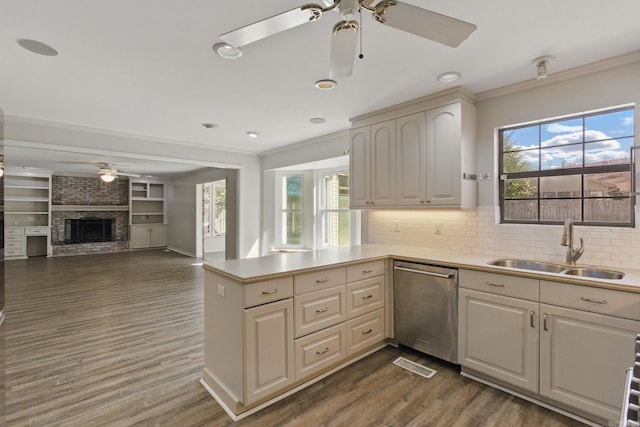 kitchen featuring dishwasher, ornamental molding, plenty of natural light, and a sink