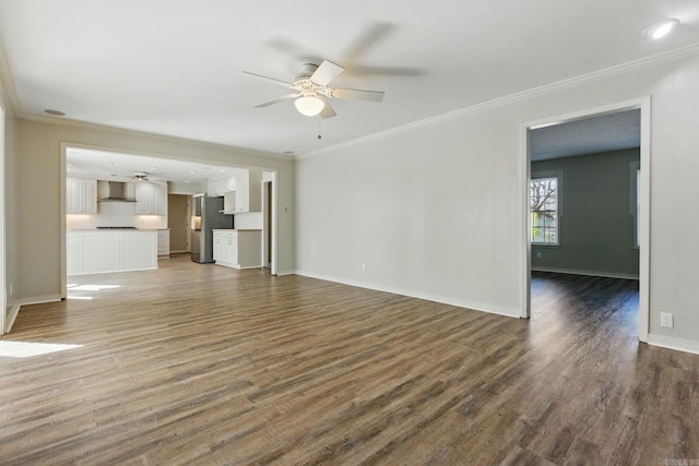 unfurnished living room featuring a ceiling fan, ornamental molding, baseboards, and wood finished floors