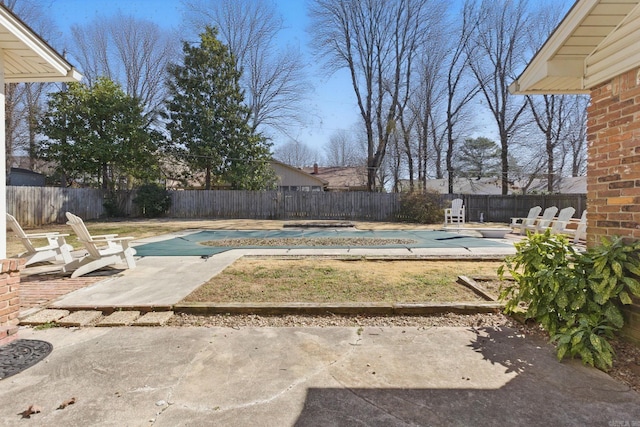 view of yard featuring a patio area, a fenced backyard, and a fenced in pool