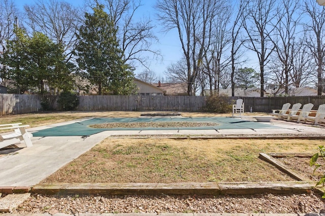 view of swimming pool featuring a fenced in pool, a patio area, a fenced backyard, and a lawn