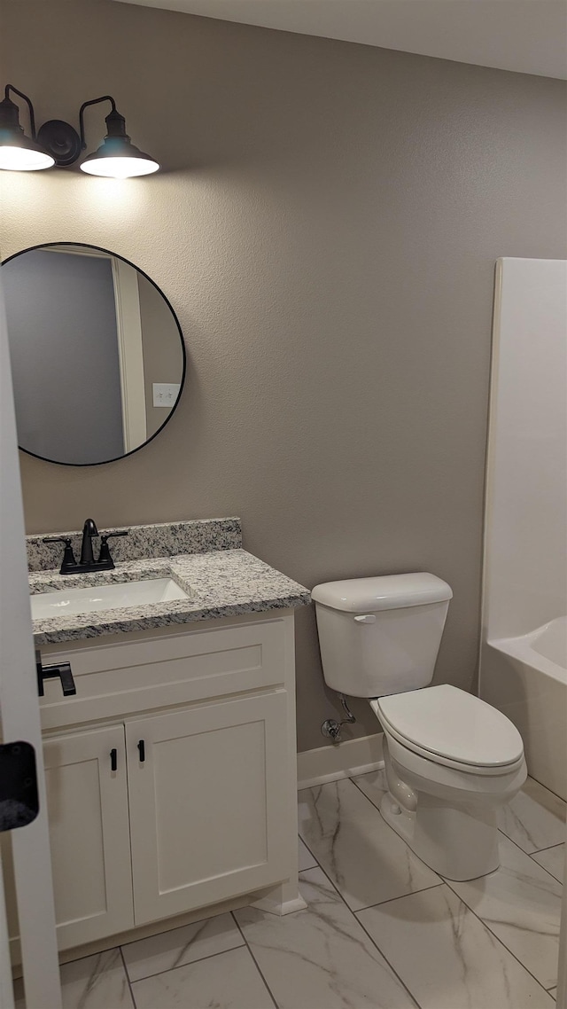 full bathroom featuring marble finish floor, vanity, toilet, and baseboards