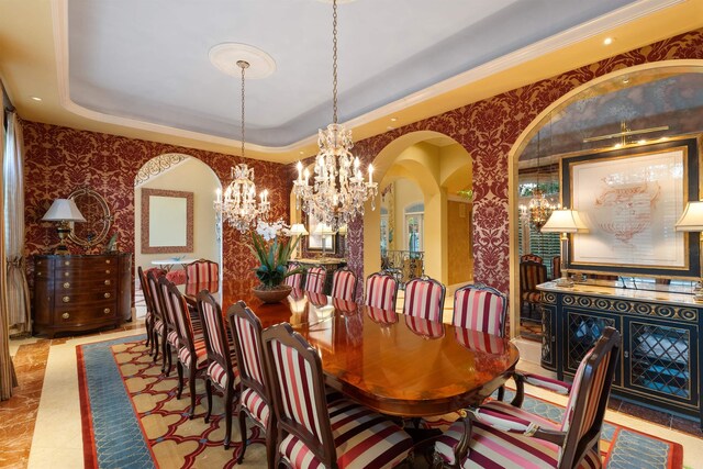 dining area with a raised ceiling, an inviting chandelier, and wallpapered walls