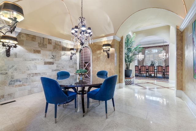 dining room with arched walkways, baseboards, visible vents, and a notable chandelier