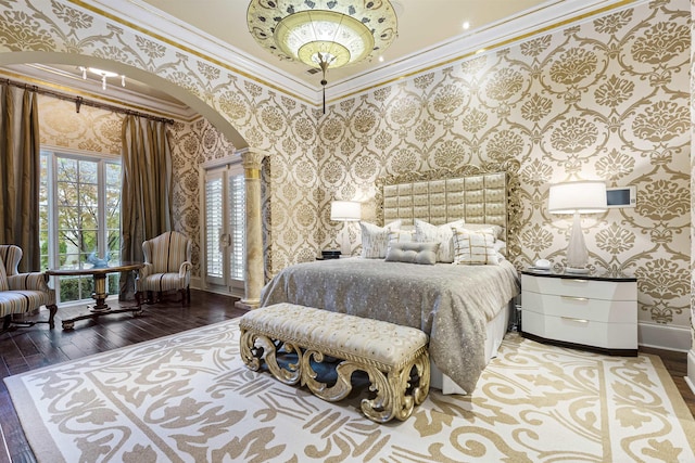 bedroom featuring arched walkways, baseboards, wallpapered walls, hardwood / wood-style floors, and crown molding