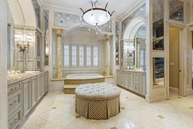 bathroom featuring decorative columns, ornamental molding, a garden tub, tile patterned flooring, and vanity