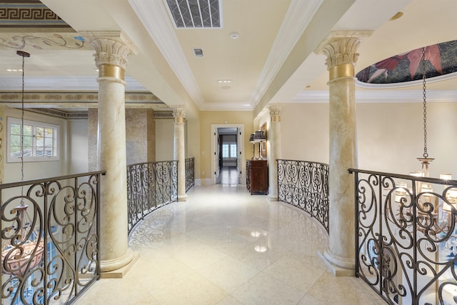 corridor featuring ornate columns, visible vents, crown molding, and an upstairs landing