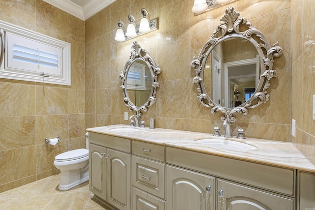 bathroom with toilet, a sink, tile walls, ornamental molding, and double vanity