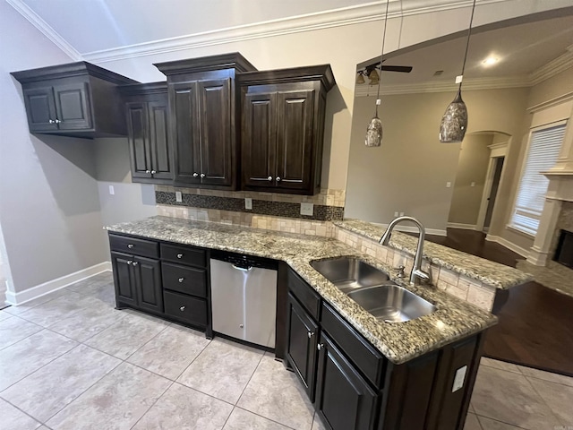 kitchen with arched walkways, decorative backsplash, ornamental molding, a sink, and dishwasher