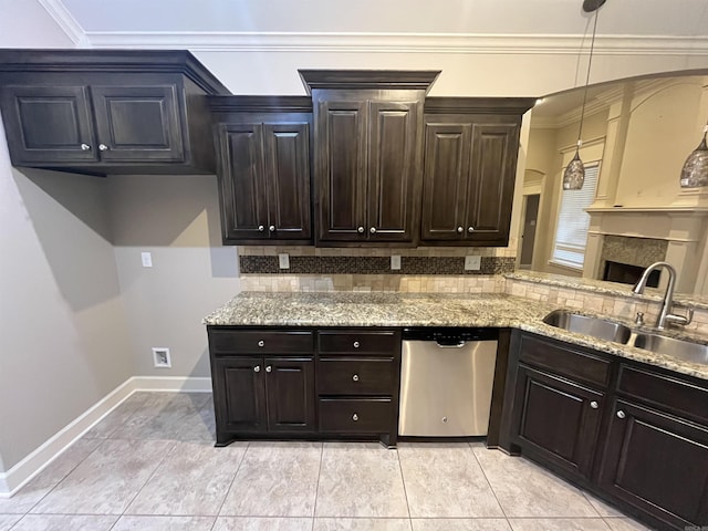 kitchen featuring dishwasher, tasteful backsplash, a sink, and light stone counters