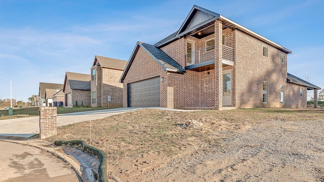 view of front of property featuring brick siding, an attached garage, board and batten siding, a balcony, and driveway