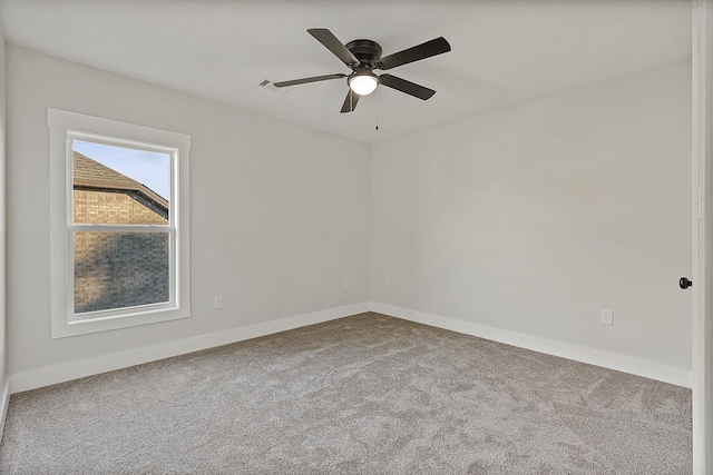 empty room with carpet floors, baseboards, and a ceiling fan