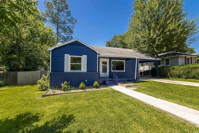 view of front facade featuring driveway, an attached carport, fence, a front lawn, and brick siding