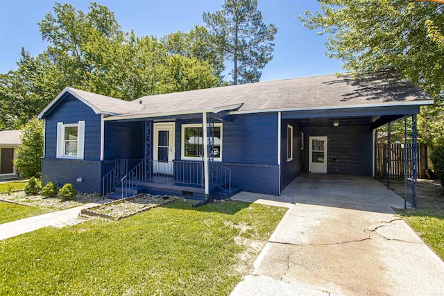 view of front facade featuring driveway, brick siding, a front yard, and an attached carport