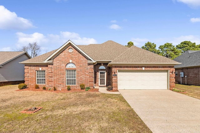 ranch-style home with concrete driveway, brick siding, a front lawn, and roof with shingles