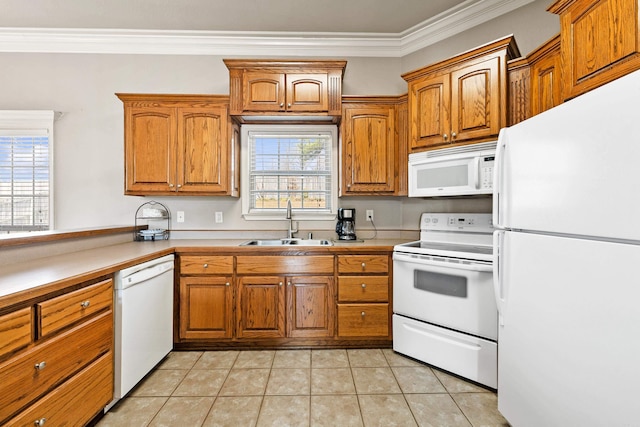 kitchen featuring white appliances, brown cabinets, a sink, and light tile patterned floors