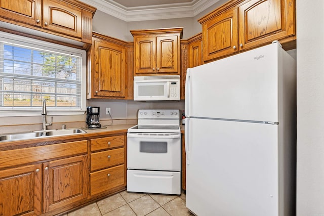 kitchen featuring white appliances, a sink, light countertops, ornamental molding, and brown cabinetry