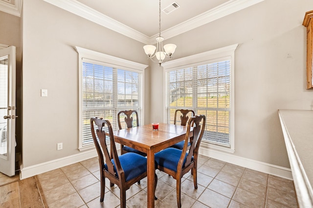 dining room featuring an inviting chandelier, baseboards, visible vents, and ornamental molding