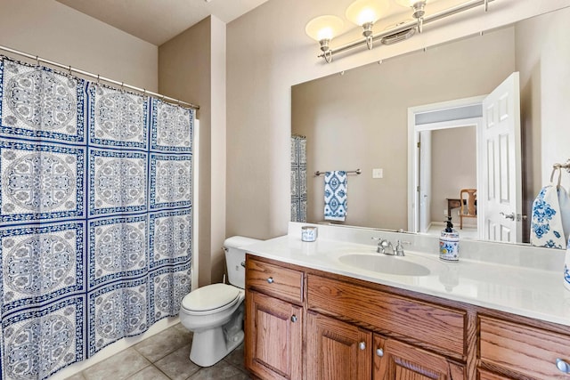 bathroom with toilet, curtained shower, vanity, and tile patterned floors