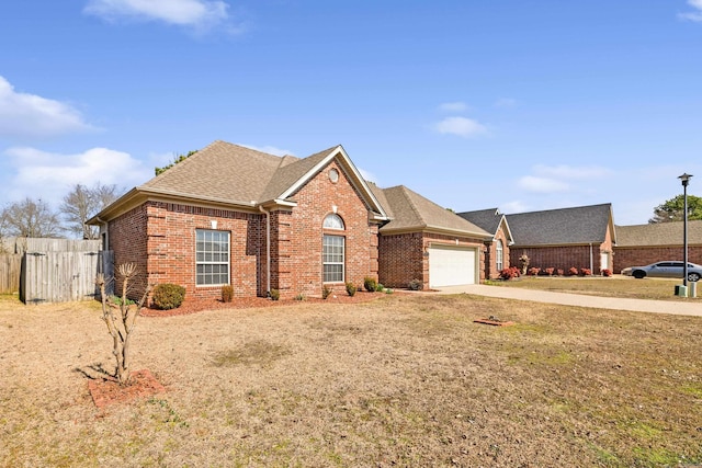 view of front of property featuring driveway, a garage, a shingled roof, fence, and brick siding