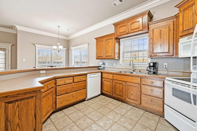 kitchen featuring brown cabinetry, white appliances, visible vents, and a sink