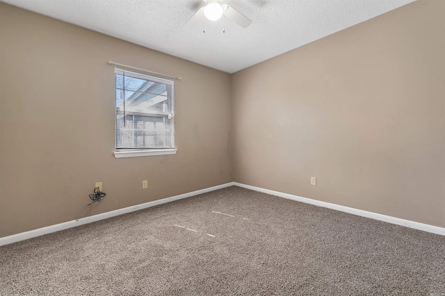 spare room with a textured ceiling, ceiling fan, carpet flooring, and baseboards