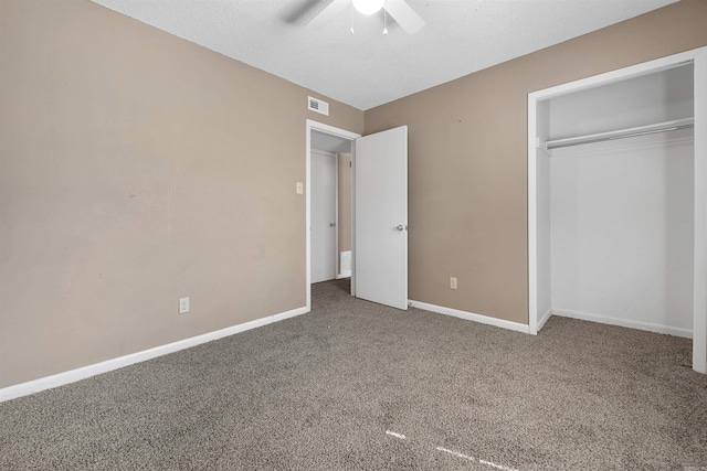 unfurnished bedroom featuring carpet, a closet, visible vents, a ceiling fan, and baseboards