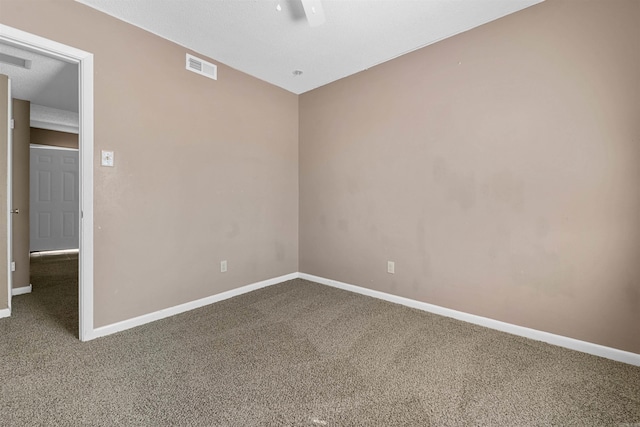 carpeted empty room with visible vents and baseboards