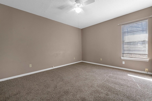 empty room featuring carpet floors, ceiling fan, baseboards, and a textured ceiling