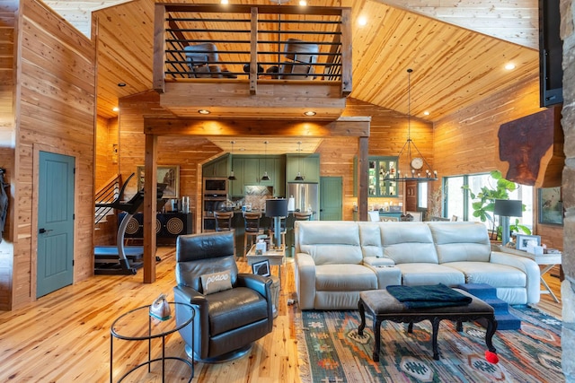 living area with high vaulted ceiling, light wood-type flooring, wood ceiling, and wooden walls