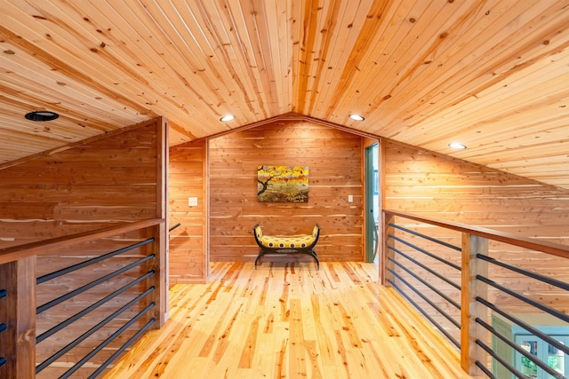 hall with lofted ceiling, wooden ceiling, wood walls, and wood-type flooring