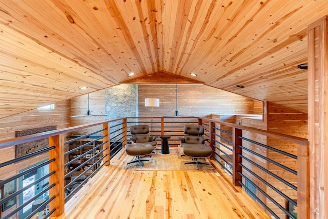 living area featuring wooden walls, a ceiling fan, wood ceiling, vaulted ceiling, and wood-type flooring